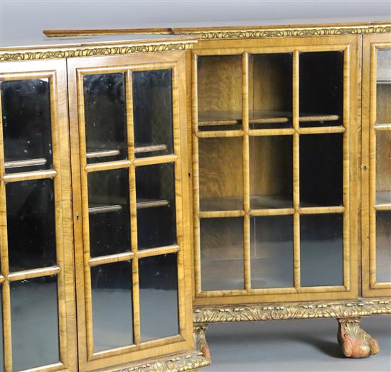 A pair of early 20th century feather banded walnut breakfront dwarf bookcases, W.4ft 8in. D.1ft 4in. H.3ft 5in.